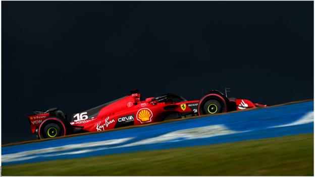 Ferrari's Charles Leclerc drives with a dark sky as the background during Sao Paulo Grand Prix qualifying