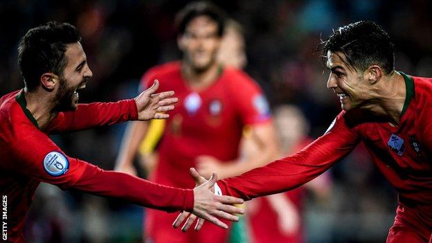 Cristiano Ronaldo celebrates with Bernardo Silva