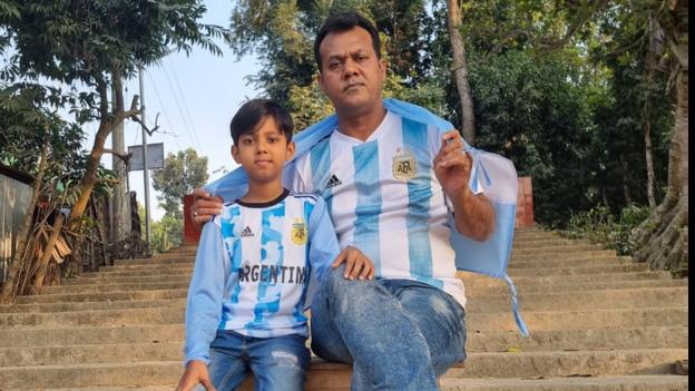 Mashiur Rahman and his son Nafi sat together in football shirts