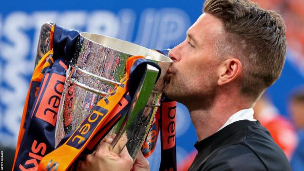 Rob Edwards kisses the Championship play-off final winners' trophy