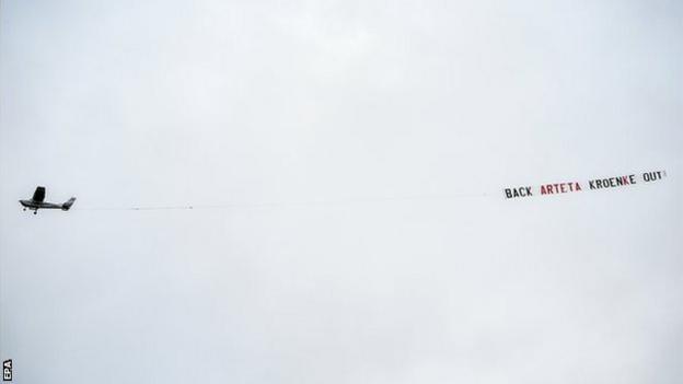 A plane towing a banner flies over Villa Park during Aston Villa's match with Arsenal