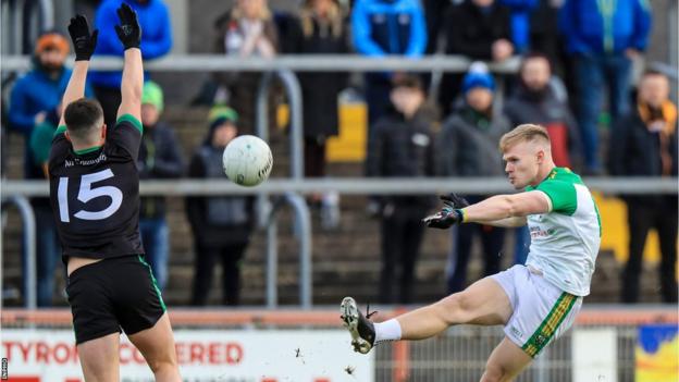 Cargin's Tomas McCann attempts to block a Conor Convery clearance at Healy Park