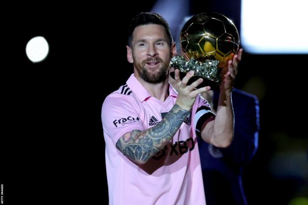 Lionel Messi holds the Ballon d'Or