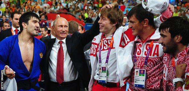 Russian President Vladimir Putin (center) celebrates Tagir Khaibulaev of Russia's gold medal in men's judo -100 kg on day 6 of the London 2012 Olympic Games at ExCeL on August 2, 2012 in London, England.