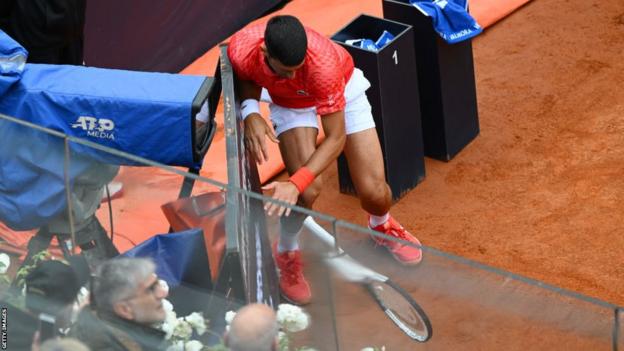 Novak Djokovic crashes into the timepiece  astatine  the broadside  of the court