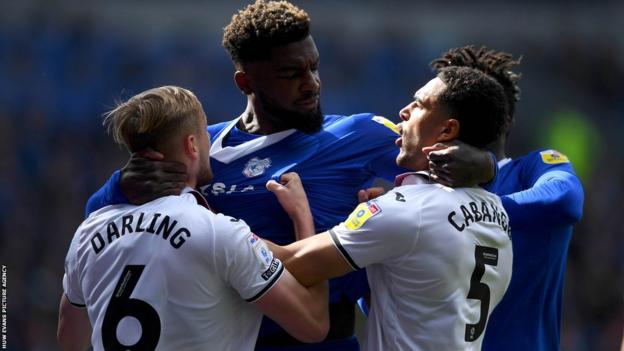 Cardiff's Cedric Kipre clashes with Swansea's Harry Darling and Ben Cabango