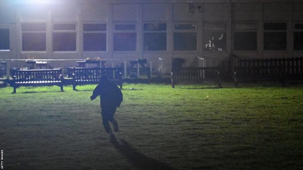 David Beckham running across a field