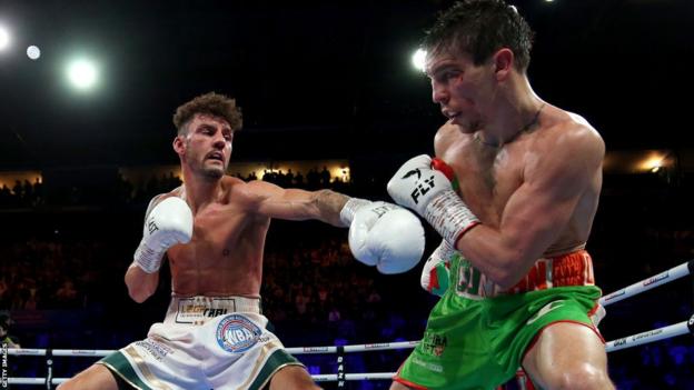 Michael Conlan evades a punch from Leigh Wood