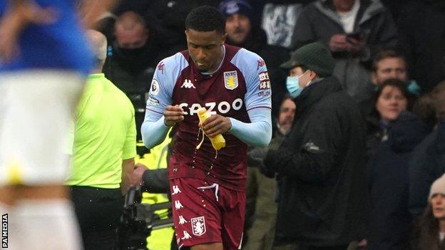 Villa's Ezri Konsa removed the lid and took a sip out of the bottle thrown