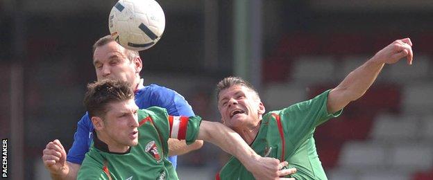 Paul Leeman and Gary Smyth challenge Glen Ferguson for the ball