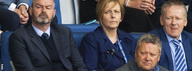 Steve Clarke, left, watched Sunday's game from the stand as he served the first match of a two-game ban