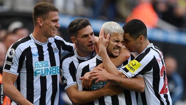 Newcastle players celebrate with Bruno Guimaraes