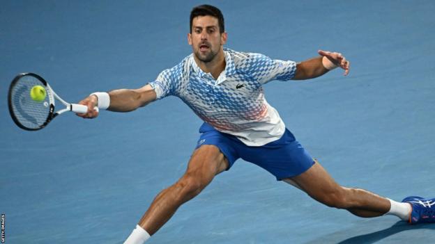 Novak Djokovic stretches for a ball in the Australian Open final against Stefanos Tsitsipas