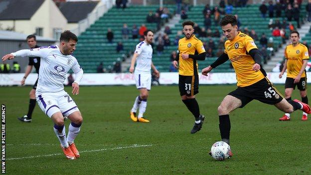 Newport County's Aaron Collins takes on Luke Gambin