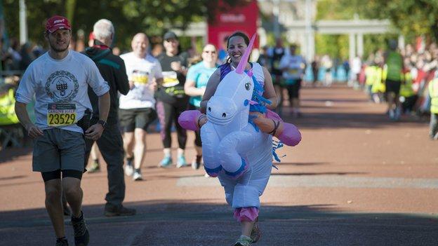 A runner in a costume finishing the Cardiff Half Marathon