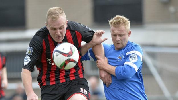 Jordan Owens battles for possession with John Currie during Crusaders's 5-0 thumping of Ballinamallard United at Seaview
