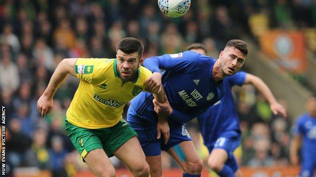 Gary Madine of Cardiff City and Grant Hanley of Norwich City look to win the ball