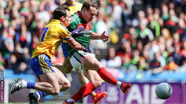 Andy Moran scores Mayo's third goal despite pressure from Roscommon's Niall Kilroy.