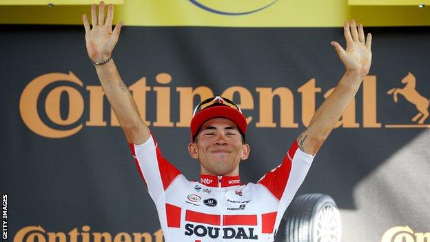 Australia's Caleb Ewan puts his hands up in celebration on the podium after winning stage 11 of the Tour de France