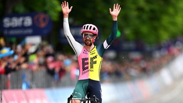 Ben Healy raises his arms as he finishes stage eight of the Giro d'Italia