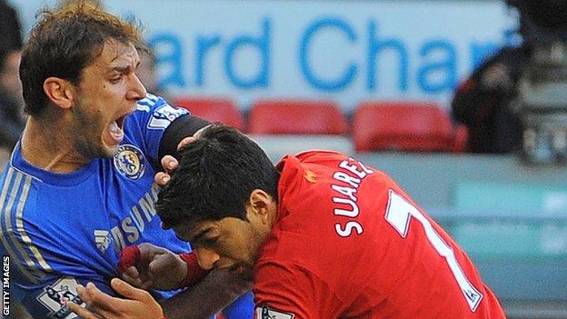 Liverpool's Luiz Suarez bites Chelsea's Branislav Ivanovic during a Premier League match at Anfield