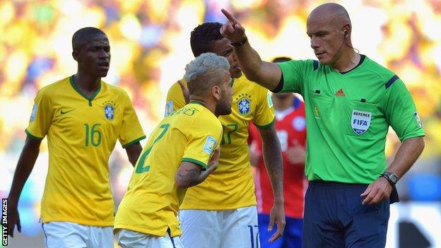 Dani Alves of Brazil reacts as referee Howard Webb calls a foul during the 2014 FIFA World Cup Brazil