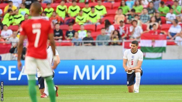 Conor Coady of England takes a knee