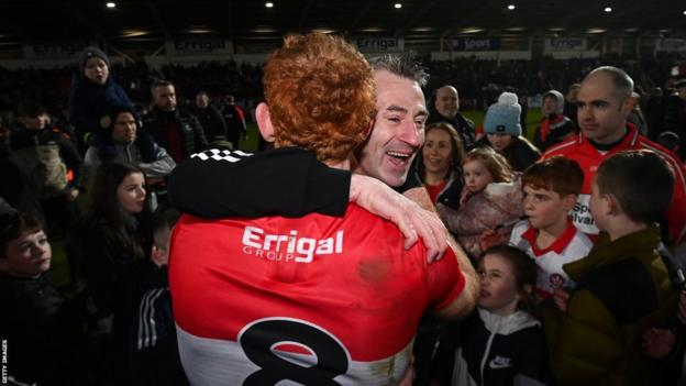 Derry boss Rory Gallagher and midfielder Conor Glass embrace after the full-time whistle