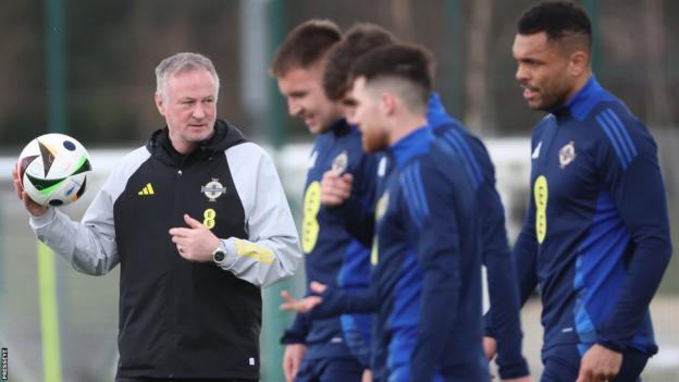 Michael O'Neill trained with his squad in Manchester before travelling to Bucharest