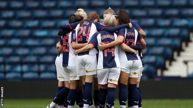 West Brom women in a team huddle