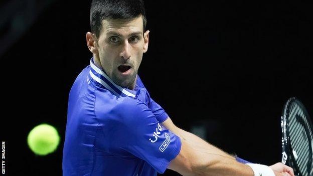 Novak Djokovic hits a backhand