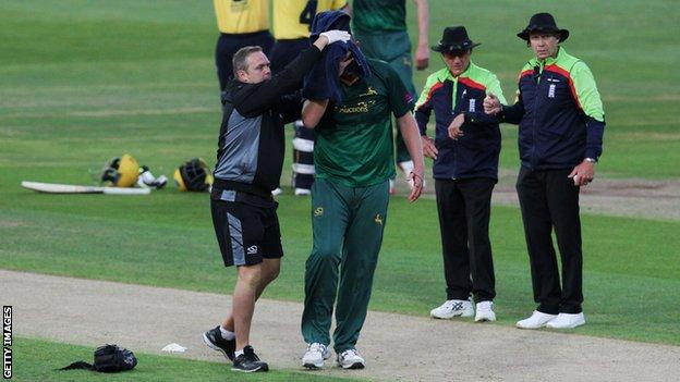 Nottinghamshire bowler Luke Fletcher is helped from the field after being struck by a ball during a Twenty20 mach against Birmingham