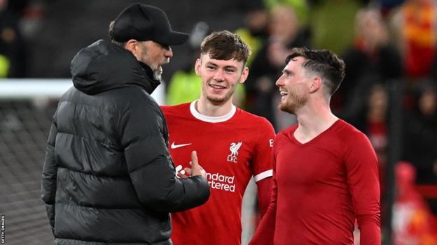 Liverpool team-mates Conor Bradley and Andy Robertson with manager Jurgen Klopp
