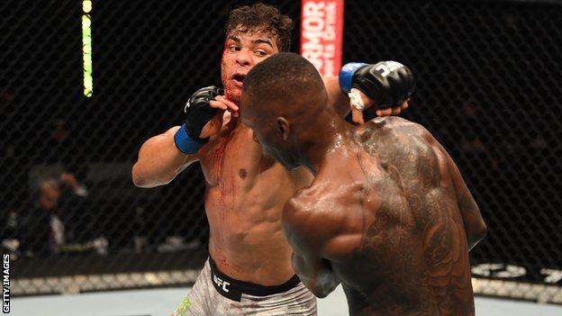 Nigeria-born Israel Adesanya (right) avoids a punch from Paulo Costa at UFC 253