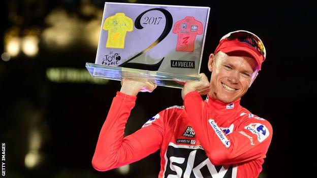 Chris Froome holds up a trophy to celebrate winning the Tour de France and Vuelta a Espana in 2017