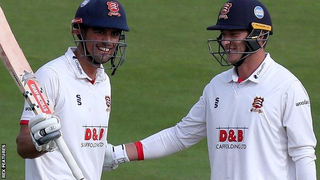 Alastair Cook is congratulated by Tom Westley on reaching his century