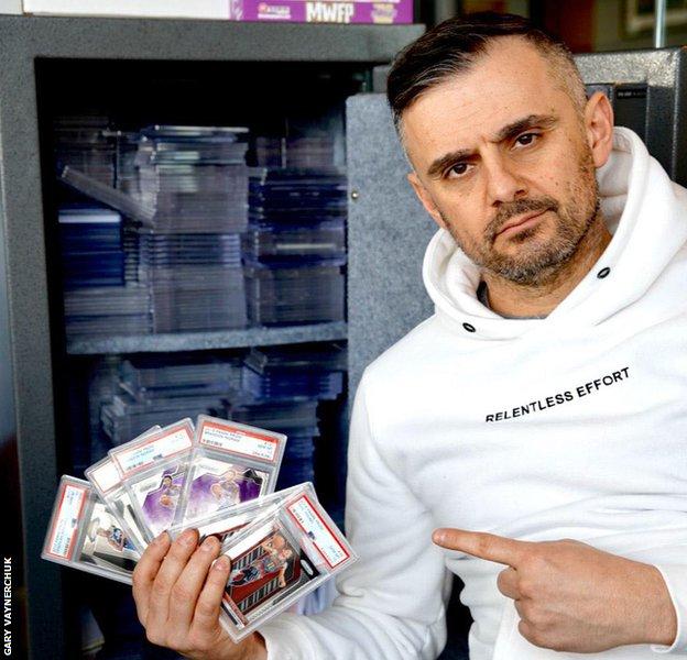 Gary Vaynerchuk holds a collection of sports cards