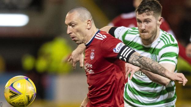 Scott Brown in action for Aberdeen, challenged by Celtic's Anthony Ralston