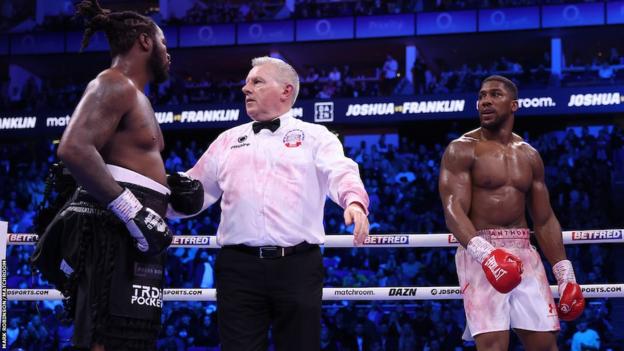 Anthony Joshua and Jermaine Franklin stare at each other towards the end of their fight