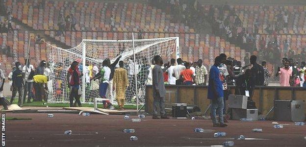 A pitch invasion at the Moshood Abiola National Stadium in Abuja