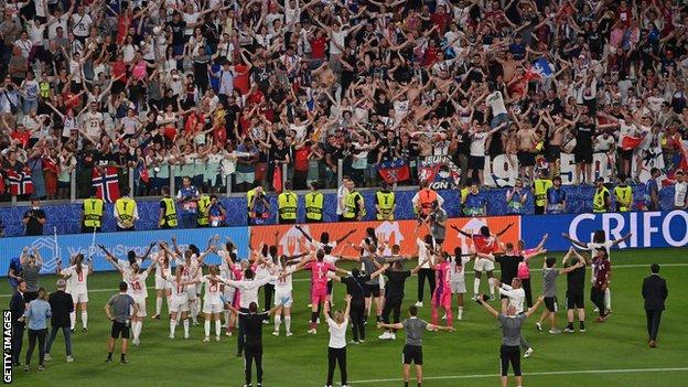 Lyon players celebrate with their fans in Turin
