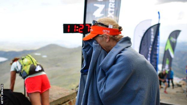 Lucy Gossage sobs into a blanket after winning the Norseman Xtreme Triathlon