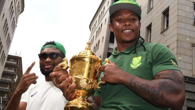 Lukhanyo Am (left) and Sbu Nkosi of South Africa pose with the Webb Ellis Cup
