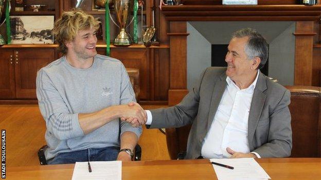 Richie Gray shakes hands with Toulouse president Jean-Rene Bouscatel after signing his deal