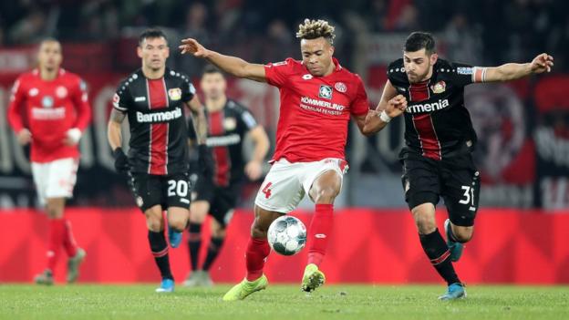 Pierre Kunde Malong of FSV Mainz 05 battles for possession with Kevin Volland of Bayer 04 Leverkusen during the Bundesliga match