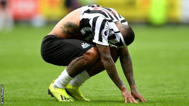 Newcastle midfielder Kenedy hides his face after missing a penalty