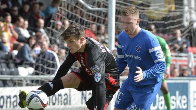 Crusaders goalscorer Diarmuid O'Carroll shields the ball from Chris Crilly
