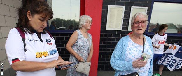 Anxious fans wait outside Bolton's stadium on Tuesday before the EFL's 17:00 BST deadline