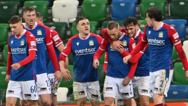 Kirk Millar is congratulated by Linfield team-mates after scoring his side's third goal