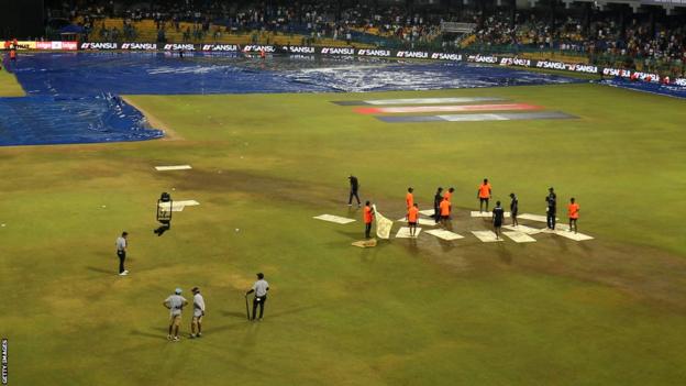 Members of the groundstaff at the R. Premadasa Stadium in Colombo attempted to dry the outfield with towels